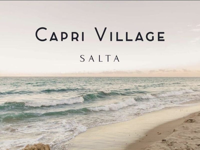 A scenic coastal view of the ocean and sandy beach, representing the location of the Capri Village Salta development.