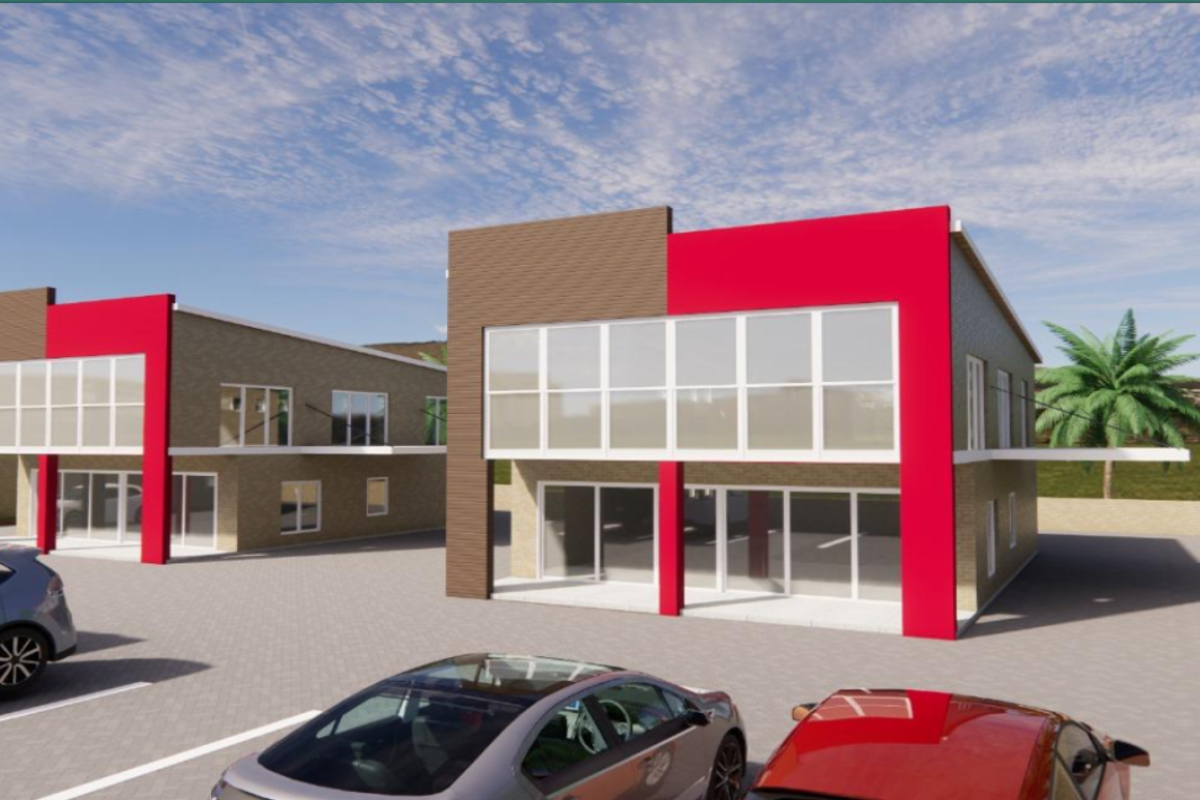 A modern architectural rendering of a multi-unit residential complex featuring contemporary brick facades, large glass windows, and a paved parking area.