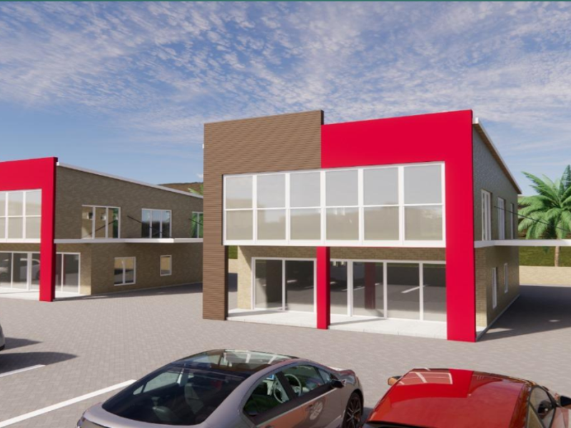 A modern architectural rendering of a multi-unit residential complex featuring contemporary brick facades, large glass windows, and a paved parking area.