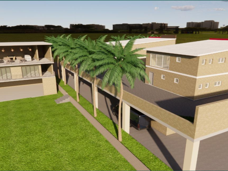 An aerial view of a modern multi-level property complex featuring clean architectural lines, balconies, and integrated parking areas set within a landscaped environment.