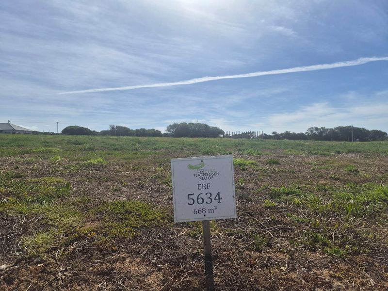A view of a vacant residential plot of land measuring 668 square meters, featuring natural vegetation and clear boundaries.