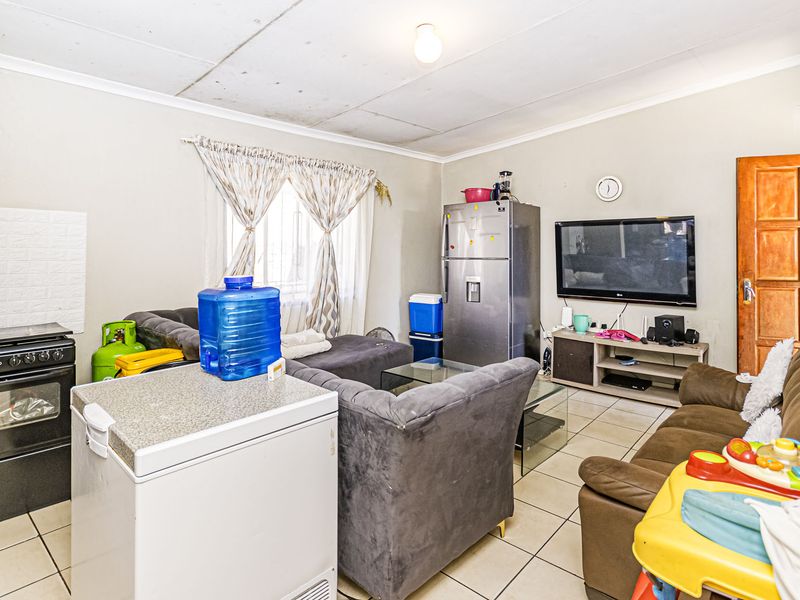 Open plan living area featuring tiled flooring and standard ceiling finishes, providing a functional space for daily living.