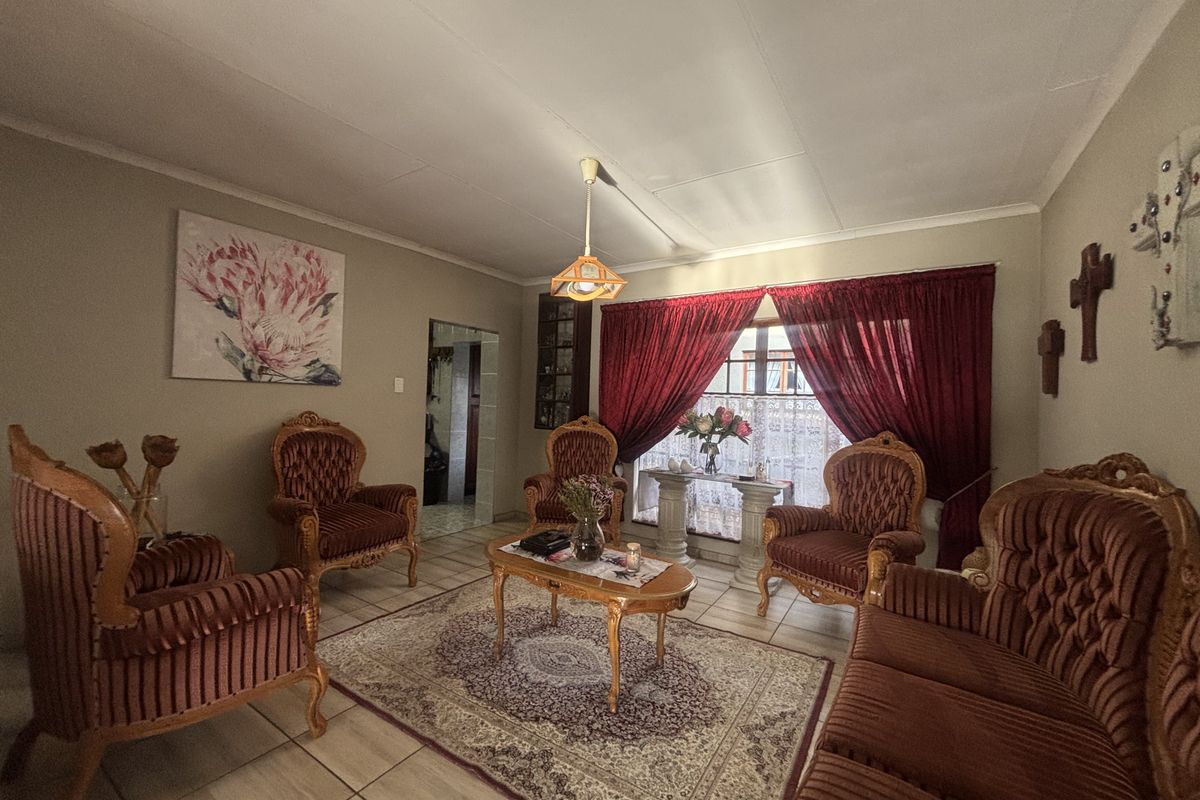 A traditional living room featuring tiled flooring and a central light fixture, offering a comfortable and classic space for relaxation.