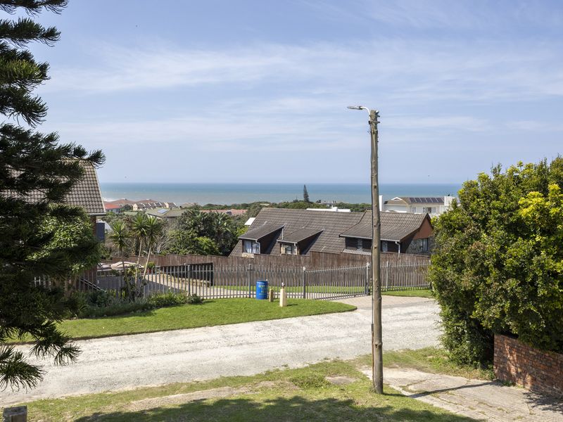 A scenic elevated view overlooking the neighbourhood with a clear outlook towards the ocean.
