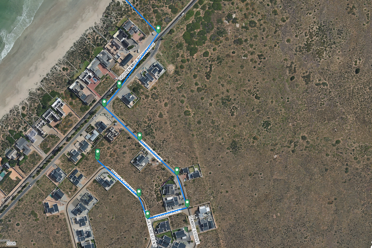 An aerial satellite view showing the coastal residential layout, street network, and surrounding natural landscape of the property area.