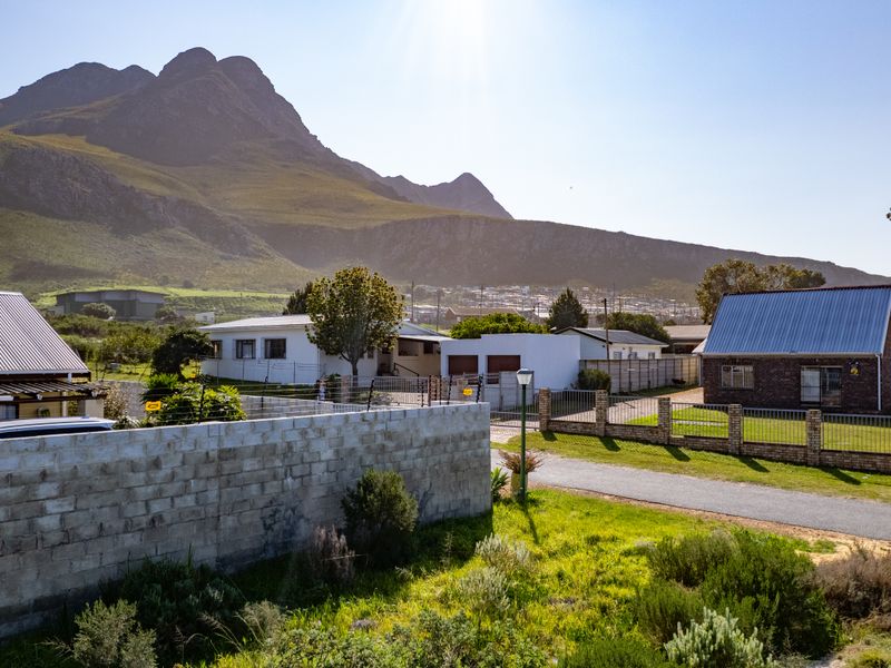 A scenic view of the surrounding residential neighborhood with a prominent mountain backdrop and clear sky.