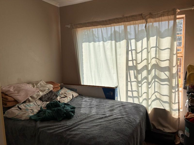 A bedroom featuring a large sliding glass door that provides natural light and access to the exterior.