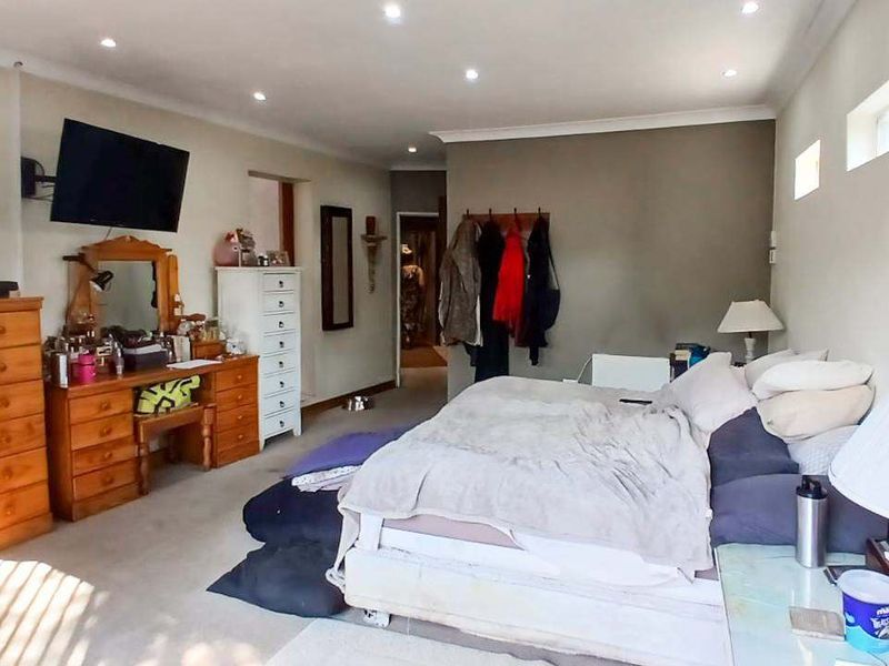 Spacious bedroom featuring recessed downlighting and coving, offering a comfortable layout with ample room for furniture.