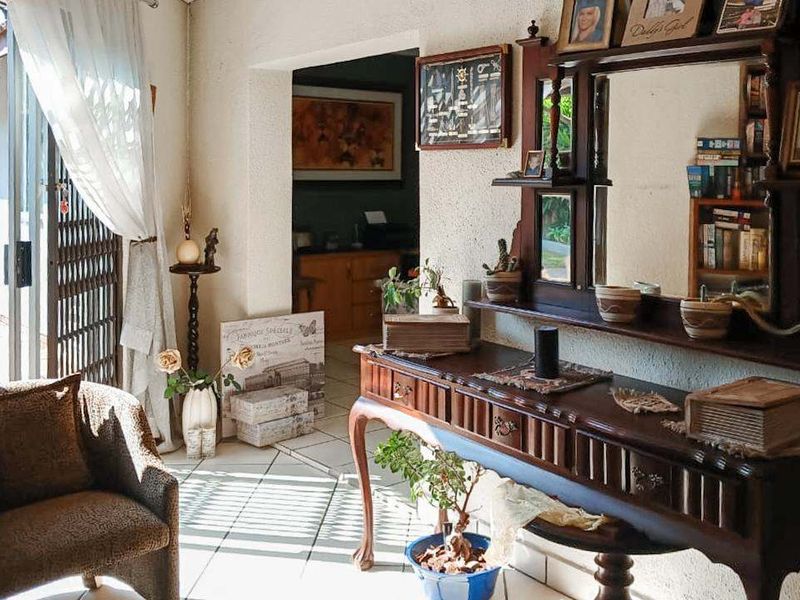 Entrance area featuring tiled flooring and a sliding glass door with security gate, providing access to the home's interior living spaces.