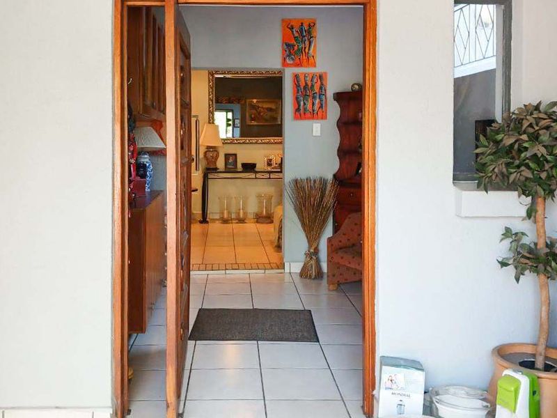 Entrance area featuring a wooden door frame and tiled flooring, providing a view into the interior living space.