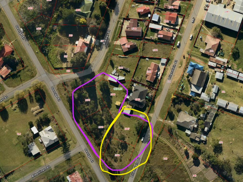 Aerial view of vacant residential land parcels highlighted in a suburban neighborhood setting.