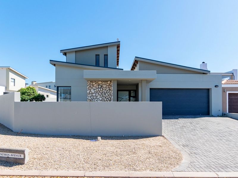 Modern contemporary house featuring a striking skillion roof, stone cladding accents, a paved driveway, and a secure double garage.