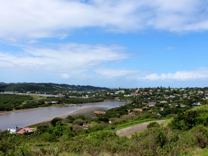 A scenic elevated view overlooking a river estuary and the surrounding residential coastal landscape.