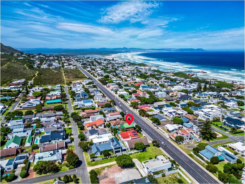An elevated aerial view showcasing the property's prime coastal location within a established residential neighborhood near the ocean.