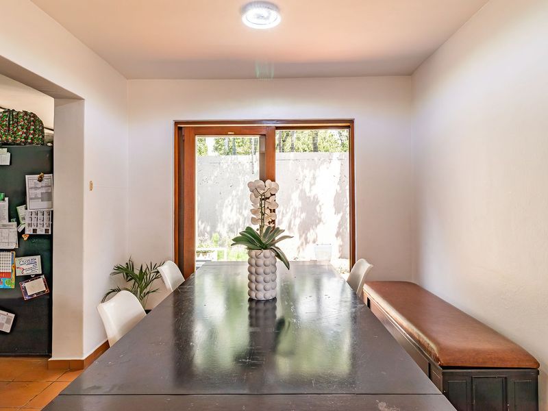 A dining room featuring tiled flooring and a sliding glass door that provides access to the outdoor area.
