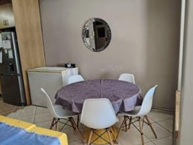 A dining area featuring tiled flooring and built-in cabinetry, providing a functional space for meals.