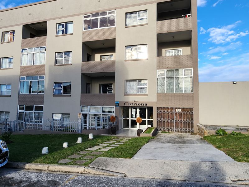 Front elevation of the Catriona apartment complex featuring a multi-story facade, paved driveway, and established lawn area.