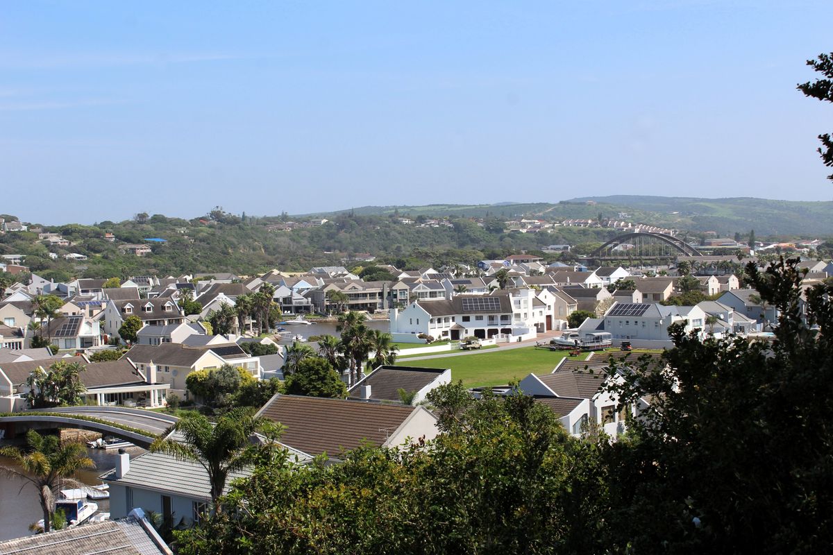 An elevated panoramic view overlooking a residential estate, surrounding landscape, and local infrastructure.