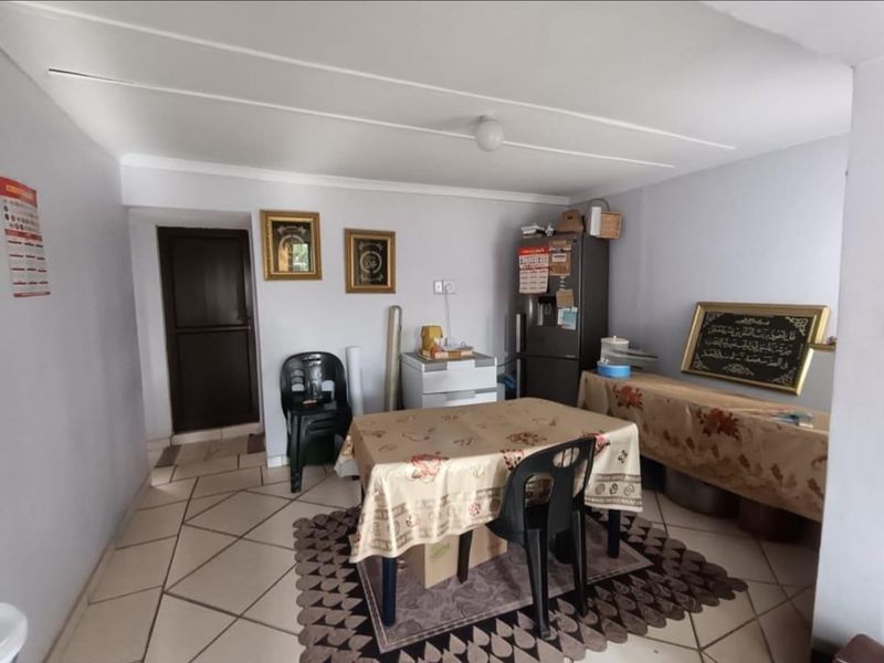 A functional living area featuring tiled flooring and neutral wall finishes, providing a versatile space for daily use.
