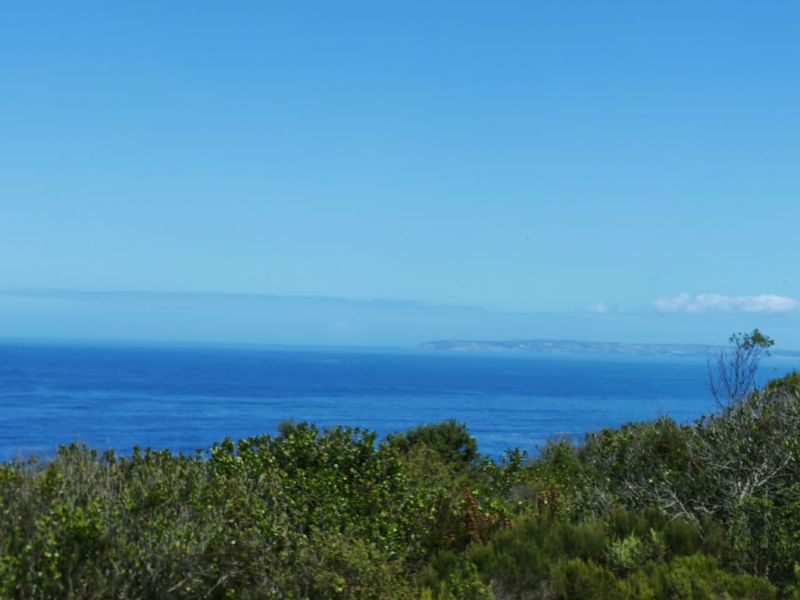 A scenic view of the ocean and distant coastline, showcasing the natural landscape of the property.
