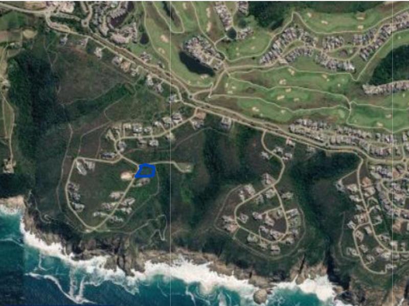 An aerial view of the residential estate showing the location of the vacant land plot within the coastal development.
