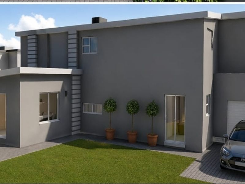 A modern two-story residential property featuring a paved driveway, attached garage, and a rear garden with a paved patio area.