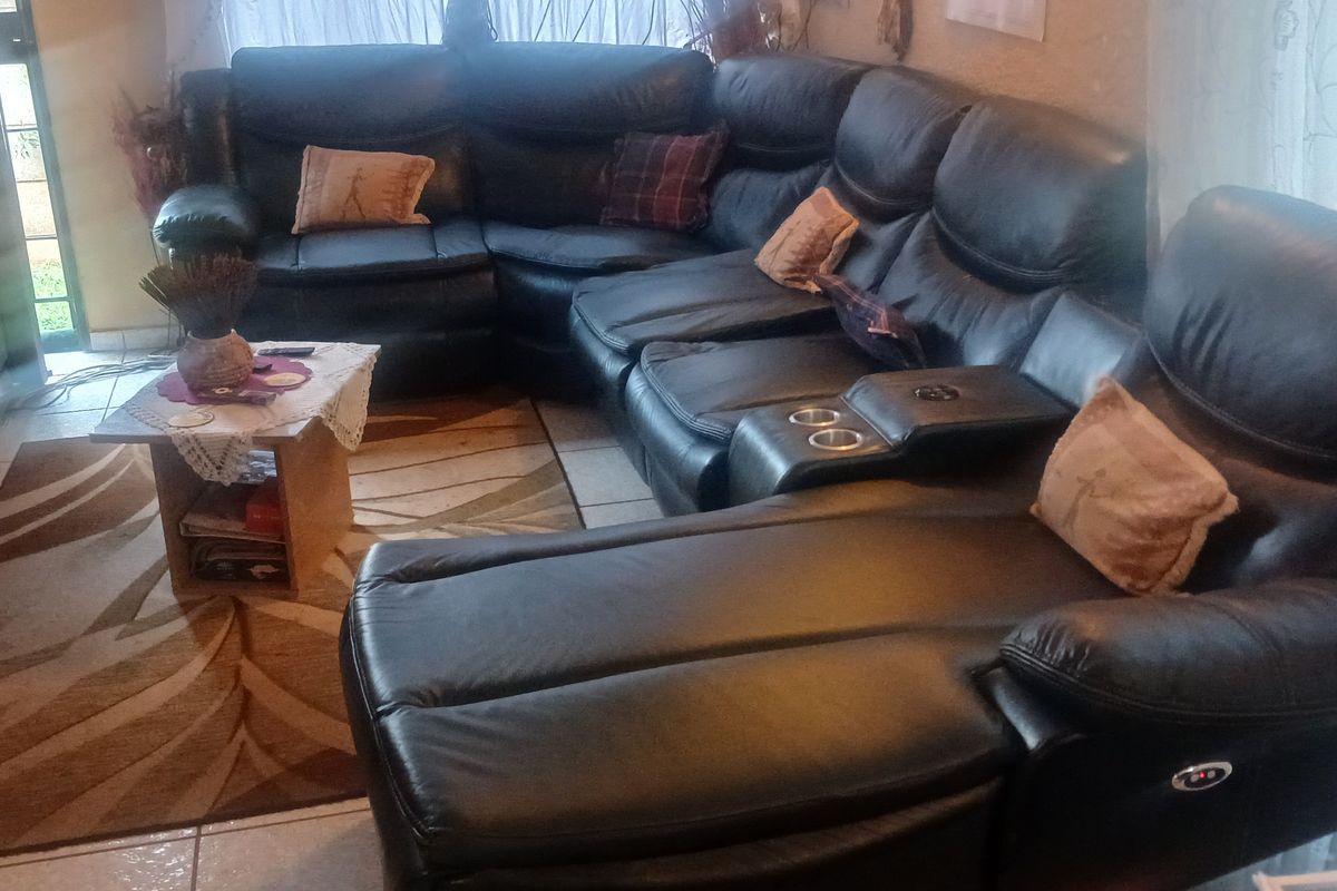 A living room area featuring tiled flooring, providing a functional space for relaxation and entertainment.