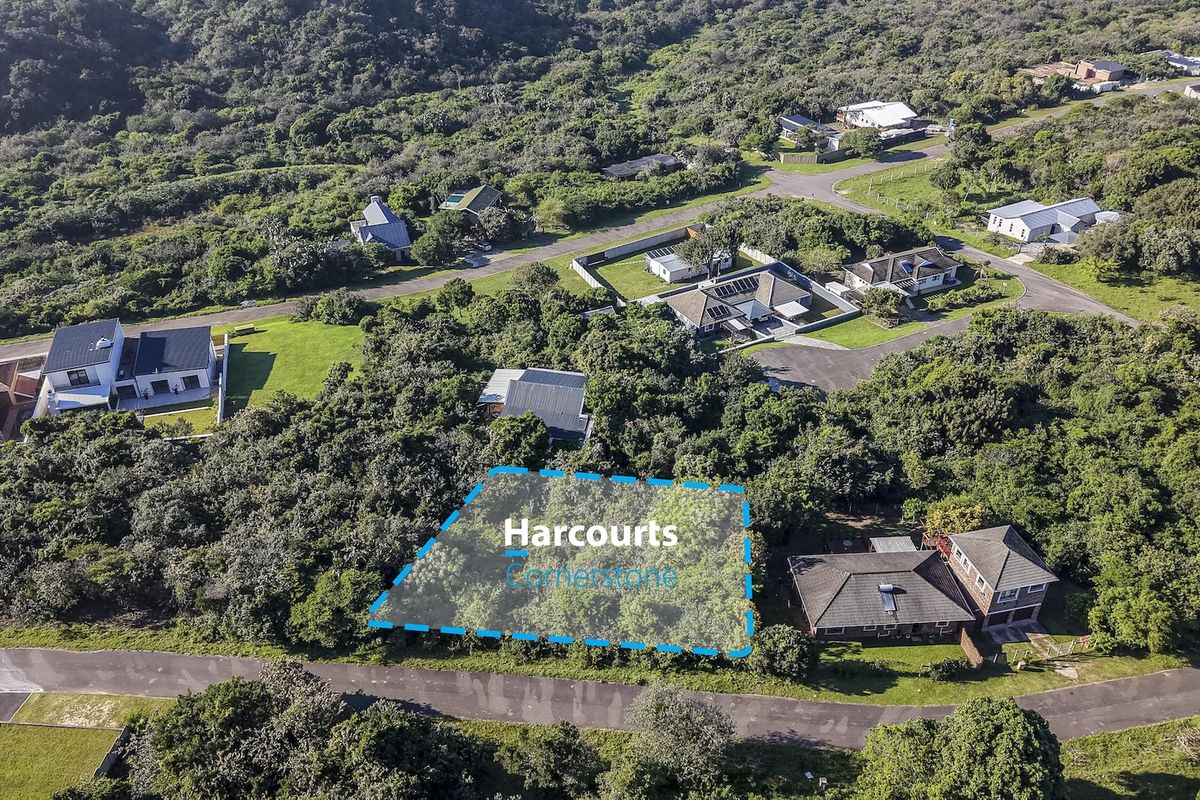 Aerial view of a vacant residential plot surrounded by established trees and neighboring properties in a quiet estate setting.