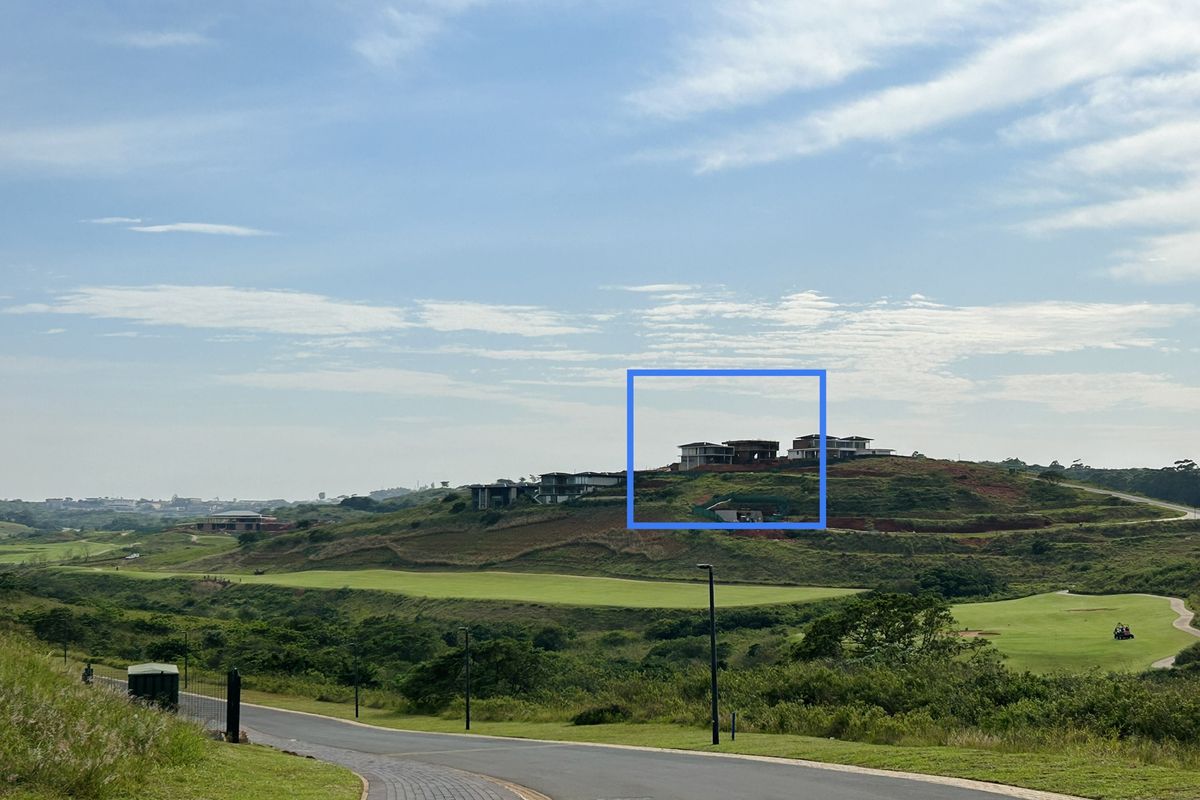 A scenic elevated view overlooking a golf course and surrounding estate landscape with residential properties visible in the distance.