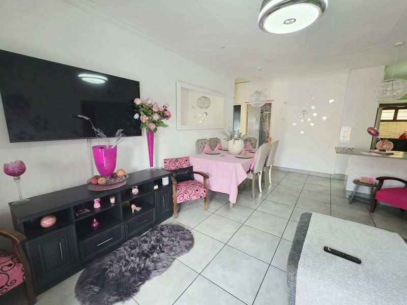 Open plan living and dining area featuring neutral tiled flooring and a bright, functional layout suitable for modern living.