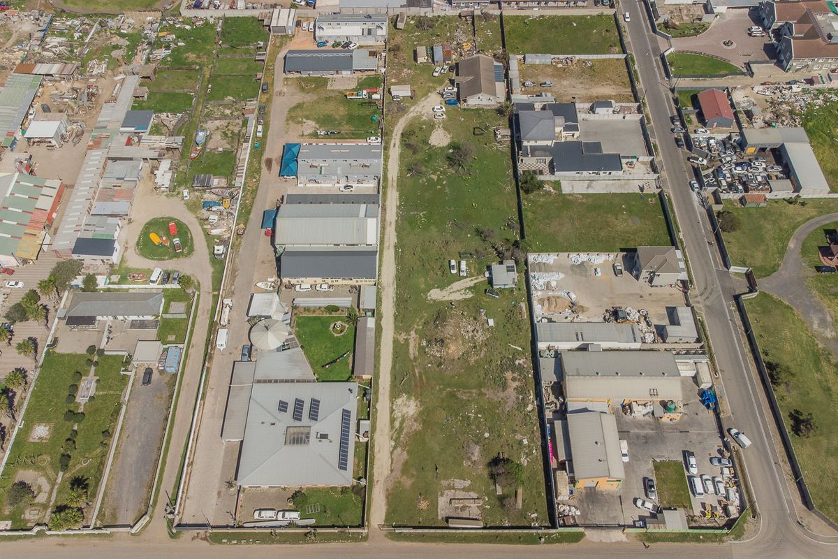 An aerial view of the property showing the building layout, roof structure, solar panels, and surrounding grounds within the estate.