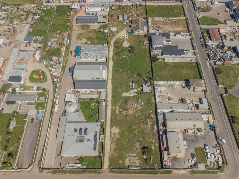 An aerial view of the property showing the building layout, roof structure, solar panels, and surrounding grounds within the estate.
