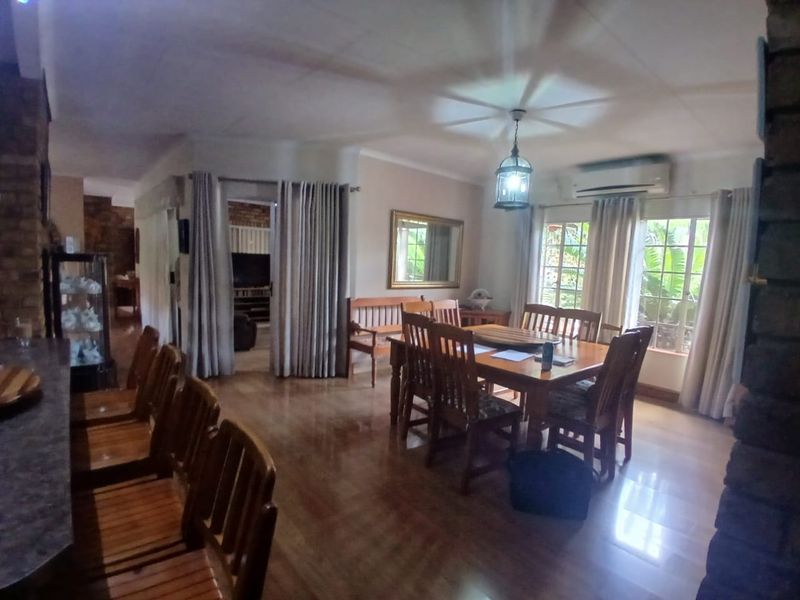 Spacious open-plan dining area featuring tiled flooring, split-system air conditioning, and natural light, providing a versatile space for family meals and entertaining.