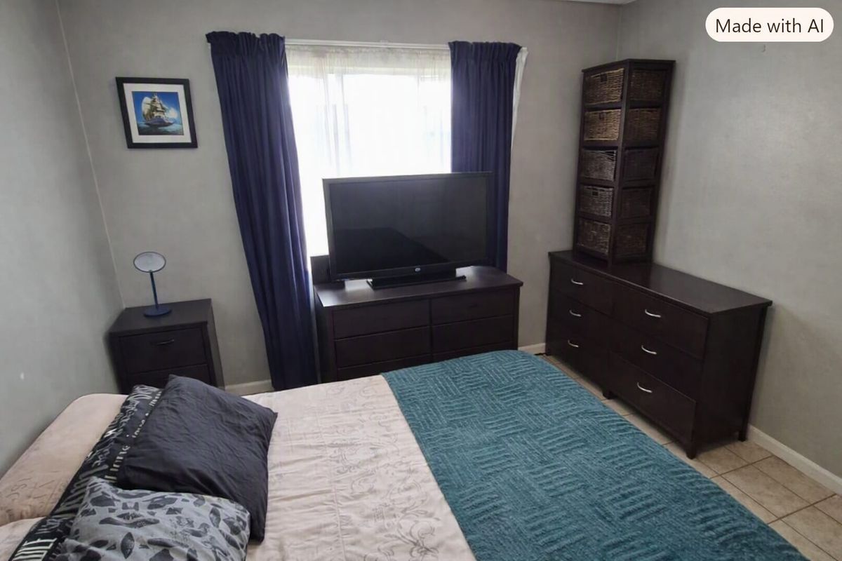 A bedroom featuring tiled flooring and a window with curtains, providing a functional space for rest.