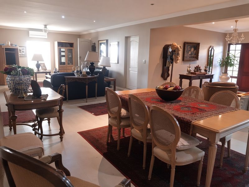 Spacious open-plan living and dining area featuring tiled flooring, recessed lighting, and coved ceilings, creating a versatile and well-connected living space.