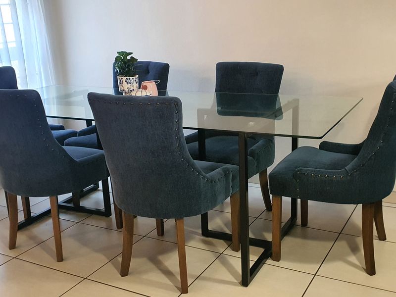 A well-lit dining area featuring neutral tiled flooring and a clean, modern aesthetic suitable for family meals and entertaining.