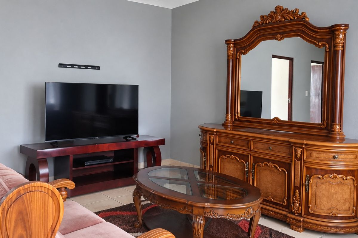 A living room featuring neutral grey walls and tiled flooring, providing a functional space for relaxation and entertainment.