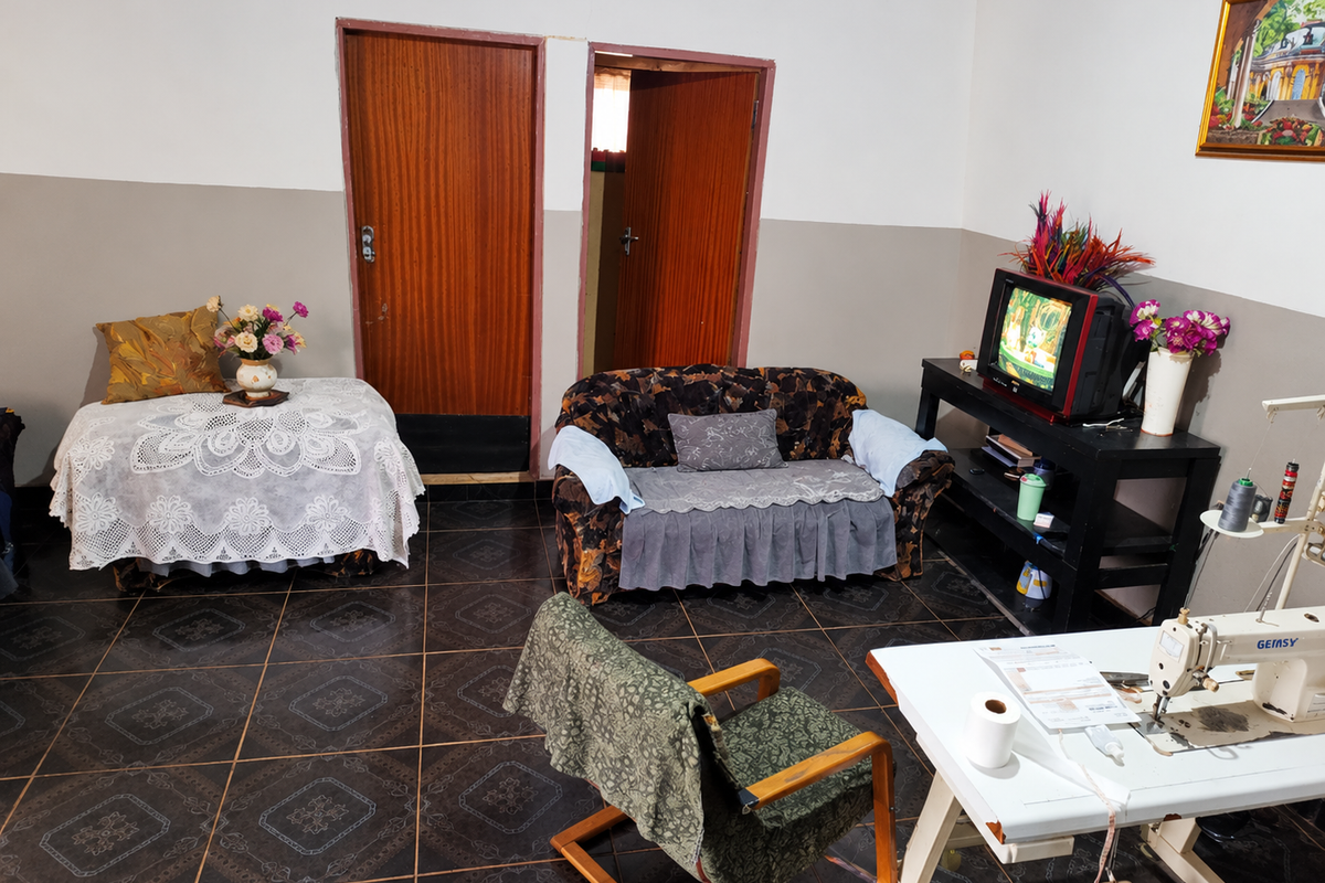A living room area featuring dark patterned floor tiles and two wooden interior doors.