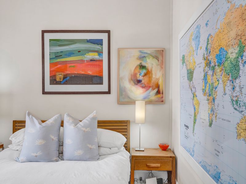 A well-maintained bedroom featuring neutral walls and a clean, bright aesthetic.