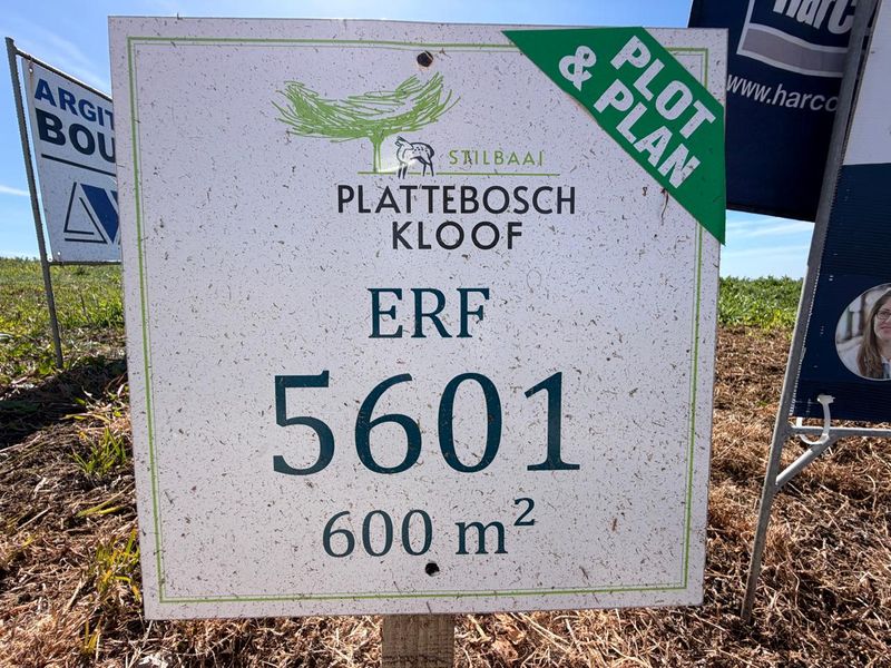 A real estate sign displaying property details for a 600 square meter residential plot in Plattebosch Kloof, Stilbaai.