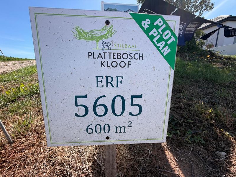A real estate signage board for a 600 square meter residential erf in Plattebosch Kloof, Stilbaai, indicating a plot and plan opportunity.