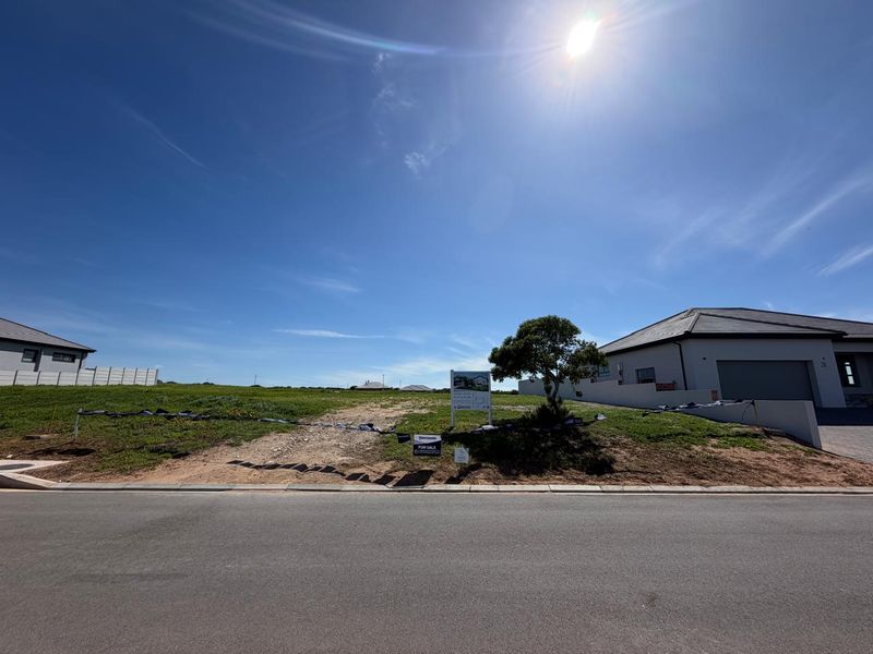A vacant residential plot situated in a developed neighborhood, featuring street frontage and clear boundaries, ready for new construction.