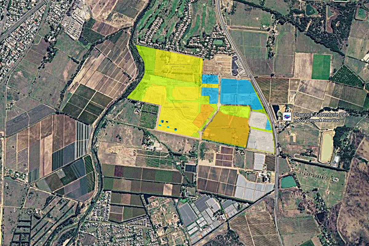 An aerial view showing land zoning and development layout for a residential and mixed-use estate area.