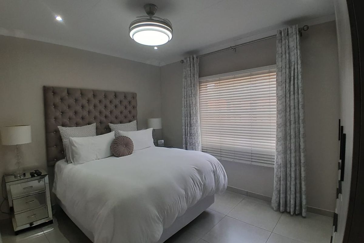 A well-maintained bedroom featuring tiled flooring, recessed lighting, a ceiling fan, and venetian blinds for privacy.