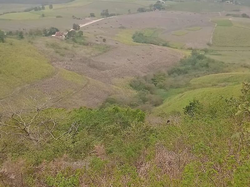 Expansive landscape view overlooking rolling hills and rural farmland terrain.