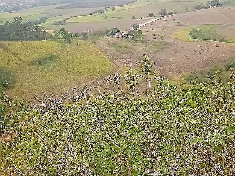 Expansive elevated landscape view overlooking rolling hills and rural farmland terrain.