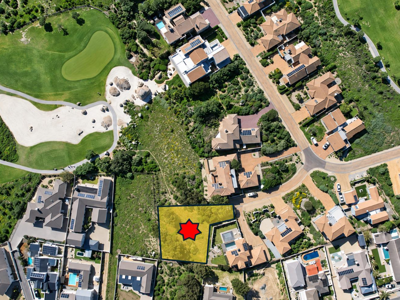 An aerial view of a vacant residential land plot situated within a developed estate, adjacent to a golf course.