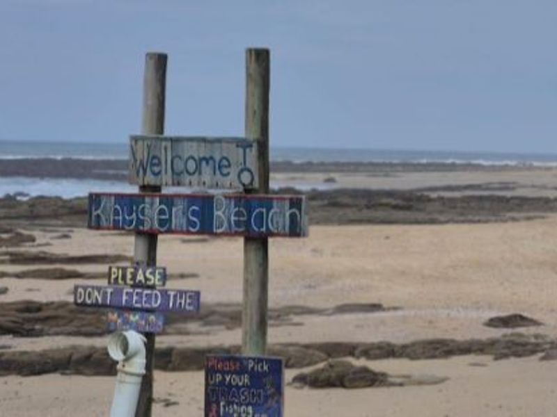 A scenic view of the coastline at Kayser's Beach, featuring sandy shores and rocky outcrops.