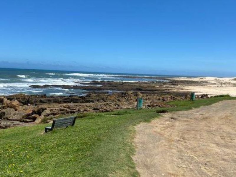 A scenic view of the rocky coastline and ocean, showcasing the natural landscape of the vacant residential property.