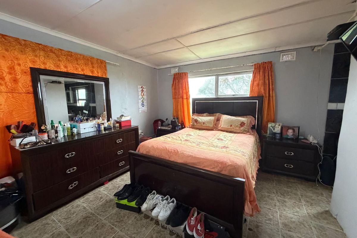 A bedroom featuring tiled flooring and a tiled ceiling, requiring cosmetic updates to the wall finishes and ceiling to improve the overall aesthetic.